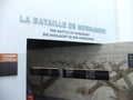 One of the doors of the Second World War memorial museum with information plaques about the battle of Normandy