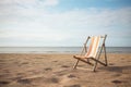 one empty deck chair on a desolate beach