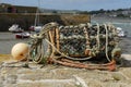 One empty lobster pot on harbour wall. Royalty Free Stock Photo