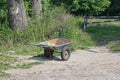 one empty old metal green rusty garden wheelbarrow Royalty Free Stock Photo