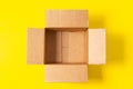 One empty open cardboard box on yellow background. Top view, copy space Royalty Free Stock Photo