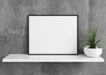 Single 8x10 Horizontal Pink Frame mockup with green plant in vase on white shelf and concrete wall behind it Royalty Free Stock Photo