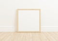 Single 10x10 Square Wood Frame mockup on wooden floor and white wall