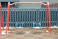 One empty red metal swings on a playground in white snow Royalty Free Stock Photo