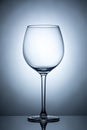 One empty wineglass for red wine on diffusion lit background Royalty Free Stock Photo