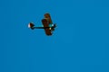 Biplane flying in blue sky Royalty Free Stock Photo