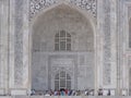 One of the entrances of the white marble mausoleum with four minarets and large domes. Taj Mahal Royalty Free Stock Photo