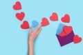 From one envelope go out a lot of red heart with one blue heart that the girl`s hand want to catch. love Valentine day on 14th
