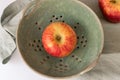 One Envy Apple in a Colander