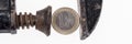 One Euro coin in a black clamp isolated. Panoramic picture Royalty Free Stock Photo