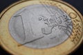 1 one euro coin close-up. The name of the Eurozone currency in focus. Background for news about economy and finance of the Royalty Free Stock Photo