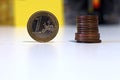 One euro coin and stack of cents on blurred background Royalty Free Stock Photo