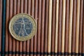 One euro coin lie on wooden bamboo table Denomination is 2 euro - back side Royalty Free Stock Photo