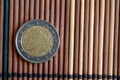 One euro coin lie on wooden bamboo table Denomination is 2 euro - back side Royalty Free Stock Photo