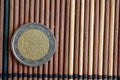 One euro coin lie on wooden bamboo table Denomination is 2 euro - back side Royalty Free Stock Photo