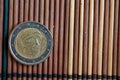 One euro coin lie on wooden bamboo table Denomination is 2 euro - back side Royalty Free Stock Photo