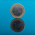 One Euro money coin on blue with reflection Royalty Free Stock Photo