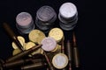 One euro, Russian ruble and small Ukrainian coins with rifle military ammo on black background. Symbolizes war for money