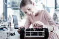 Beautiful girl smiling while constructing robotic vehicle