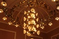 Big, gold chandelier on the ceiling in the theater. Royalty Free Stock Photo