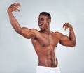 One excited African American fitness model posing topless in a underwear and looking muscular. Happy black male athlete Royalty Free Stock Photo