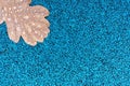 One fallen oak leaf with raindrops on blue rubber road coating in autumn park. Royalty Free Stock Photo