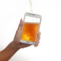 One female hand holds smart phone with pouring beer against white background