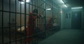 One female prisoner stands behind metal bars, another sits on the bed