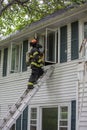 One Firefighter on Fire Scene in front of a building