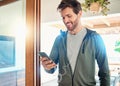 One fit young caucasian man listening to music with earphones from a cellphone while taking a break from exercise at Royalty Free Stock Photo