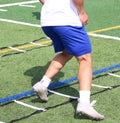 One football player close up running the ladder drill on a turf field Royalty Free Stock Photo