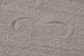 One footprint from the sole of the shoe on the gray dry sand Royalty Free Stock Photo