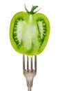 One fork with half of a green zebra tomato isolated on white background Royalty Free Stock Photo