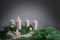 One of four candles is burning for the first Advent on fir branches with Christmas decoration against a grey background, copy Royalty Free Stock Photo