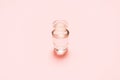 One fragrance bottle with liquid on pink background. Mock-up Royalty Free Stock Photo