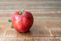 One fresh apple on wooden rustic background