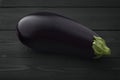 One fresh beautiful eggplant dark wooden background.