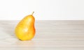One fresh juicy pear on wooden table on white background. Summer harvest. Ripe fruits. Healthy eating. Copy space for text. Close- Royalty Free Stock Photo