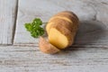 One fresh potato on wood table Royalty Free Stock Photo