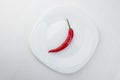 One Fresh Red Chili Peppers On A White Plate