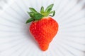 One fresh strawberry on White porcelain plate Royalty Free Stock Photo