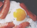 One fried egg and hot dogs