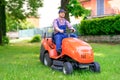 One gardener driving riding lawn mower garden Royalty Free Stock Photo