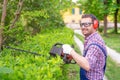 One gardener shaping hedge using hedge trimmer Royalty Free Stock Photo