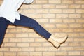 One giant leap...A cropped shot of a young man wearing boots jumping through the frame in front of a brick wall. Royalty Free Stock Photo