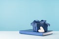 one gift box with blue bow agenda and heart on desk Royalty Free Stock Photo