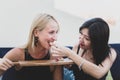 One girl treats another girl to food in a terrace restaurant.