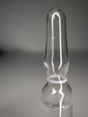 One glass ampoule on a light white background close up
