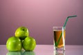 One glass of apple juice with green apples in the beautiful pink background. Reflected surface. Summer day. Good mood. Royalty Free Stock Photo