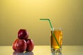 One glass of apple juice with green apples in the beautiful yellow background. Reflected surface. Summer day. Good mood Royalty Free Stock Photo